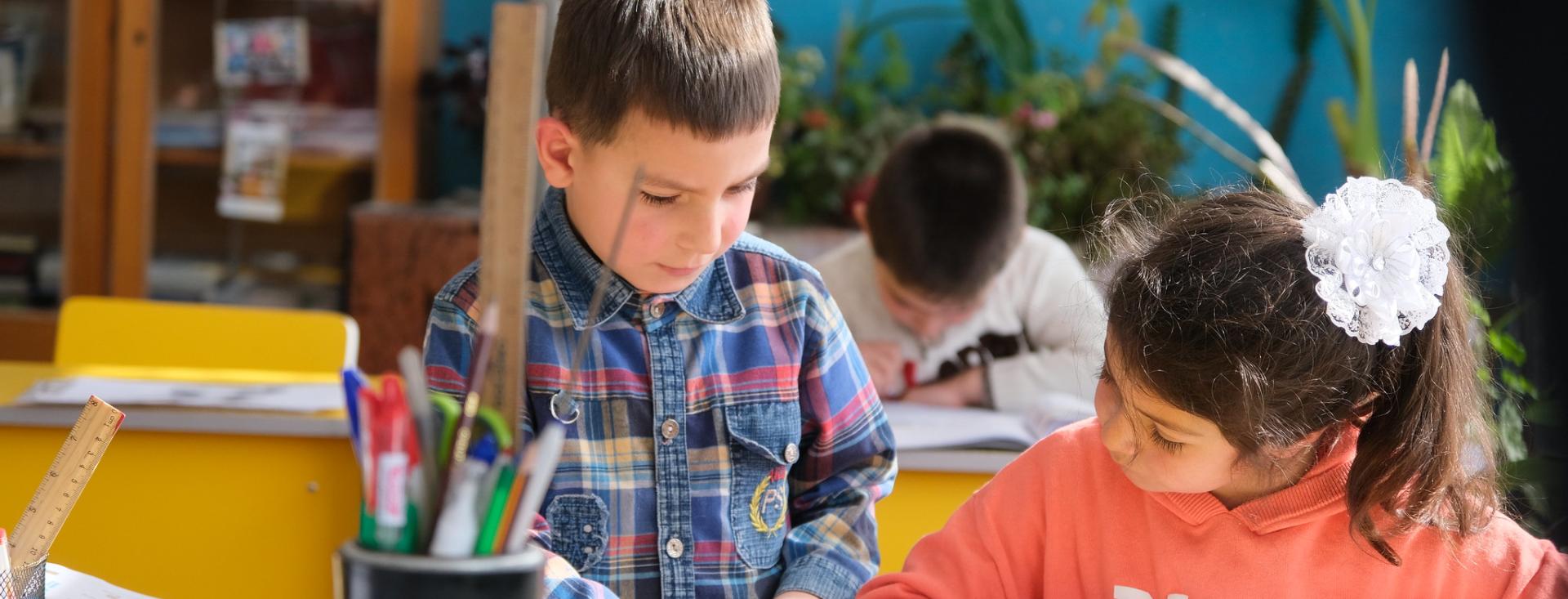 boy and girl working reading together